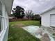 Fenced backyard with grass, partial concrete pad, and view of the detached garage at 2800 47Th S St, Gulfport, FL 33711