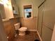 Full bathroom with a toilet, shower, and vanity with built-in storage at 2800 47Th S St, Gulfport, FL 33711