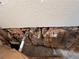 View of a damaged area in the ceiling showing exposed insulation, pipes and electrical wiring at 2800 47Th S St, Gulfport, FL 33711