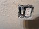 Close up view of electrical outlet and light switch on a textured wall at 2800 47Th S St, Gulfport, FL 33711