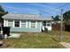 Exterior view shows a well-maintained backyard with a charming blue and white home, highlighting outdoor living at 2800 47Th S St, Gulfport, FL 33711