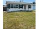 Charming home with white siding, green shutters, and a well-maintained front yard at 2800 47Th S St, Gulfport, FL 33711