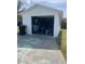 A white detached garage features an open door, storage, and ample space for parking or hobbies at 2800 47Th S St, Gulfport, FL 33711
