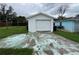 View of the detached white one-car garage with a concrete driveway and some yard space visible at 2800 47Th S St, Gulfport, FL 33711
