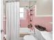 Simple bathroom with pink tile and a shower/tub combo at 3007 56Th S St, Gulfport, FL 33707