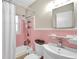 Clean bathroom with pink tile, shower/tub combo, and vanity at 3007 56Th S St, Gulfport, FL 33707