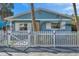 Light blue house with white picket fence and red bows at 3007 56Th S St, Gulfport, FL 33707