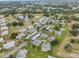 Aerial view of community, showing homes, landscaping, and a lake at 302 Canton Ct # 56, Sun City Center, FL 33573