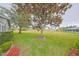Landscaped backyard with mature trees and lush lawn at 302 Canton Ct # 56, Sun City Center, FL 33573