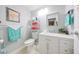 Updated bathroom with white vanity, toilet, and shower at 302 Canton Ct # 56, Sun City Center, FL 33573