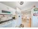 Modern kitchen with white cabinets, stainless steel appliances, and adjacent dining area at 302 Canton Ct # 56, Sun City Center, FL 33573