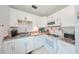 Bright kitchen features white cabinets, granite countertops, and modern appliances at 302 Canton Ct # 56, Sun City Center, FL 33573