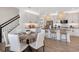 Modern kitchen and dining area with white cabinets and wood flooring at 31464 Woodland Race Loop, Wesley Chapel, FL 33545