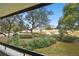 Balcony view of trees and landscaping with construction in the background at 36750 Us Highway 19 # 24212, Palm Harbor, FL 34684