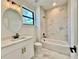 Bathroom with marble tile, white vanity and bathtub at 4204 N 13Th St, Tampa, FL 33603