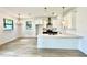 Open kitchen with island, white cabinets, and stainless steel appliances at 4204 N 13Th St, Tampa, FL 33603