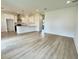 Open living room and kitchen with light flooring and white walls at 4204 N 13Th St, Tampa, FL 33603