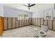 Bathroom mid-renovation showing exposed framing, concrete floor, toilet, and window with shutters at 4831 W San Miguel St, Tampa, FL 33629