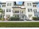 Front view of a white two-story townhome with a balcony at 5351 Bridge St # 22, Tampa, FL 33611