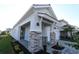 Charming single Gathering home featuring a stone columned porch with a walkway and manicured landscaping at 633 Allora Ave, Nokomis, FL 34275