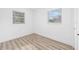 Simple bedroom with light walls and wood-look flooring at 8407 N Orangeview Ave, Tampa, FL 33617