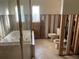 A bathroom with a bathtub and toilet under renovation at 909 Mandalay Ave, Clearwater Beach, FL 33767