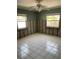 Bedroom with tiled floors, neutral-colored walls, and two windows bringing in natural light at 909 Mandalay Ave, Clearwater Beach, FL 33767