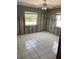 Bright bedroom with tiled floors and two windows offering plenty of natural light at 909 Mandalay Ave, Clearwater Beach, FL 33767
