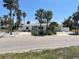 Charming single-story home with a well-maintained exterior, lush landscaping, and a spacious driveway at 909 Mandalay Ave, Clearwater Beach, FL 33767
