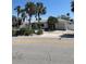 Inviting single-story house with a two car garage and mature trees at 909 Mandalay Ave, Clearwater Beach, FL 33767