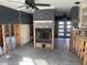 Living room with an open concept design, fireplace, gray walls, and new floors ready for renovations at 909 Mandalay Ave, Clearwater Beach, FL 33767