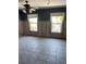 Spacious living room with tiled flooring, neutral walls, and bright windows at 909 Mandalay Ave, Clearwater Beach, FL 33767