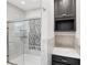 Updated bathroom with a walk-in shower and gray tile at 1106 E Chelsea St, Tampa, FL 33603