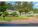 Charming house with a brick driveway and lush landscaping at 1106 E Chelsea St, Tampa, FL 33603