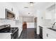 Modern kitchen with white cabinets, stainless steel appliances, and hexagon tile floor at 1106 E Chelsea St, Tampa, FL 33603