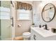 Modern bathroom with a frameless shower, vanity, and stylish fixtures at 1153 Drew St, Clearwater, FL 33755