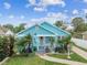 Cute light blue house with palm trees and walkway at 1153 Drew St, Clearwater, FL 33755