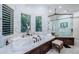 Luxurious bathroom with marble finishes, a separate shower and a soaking tub at 118 Harbor View Ln, Belleair Bluffs, FL 33770