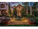 Charming stone home featuring a beautifully landscaped front yard with lush greenery and a delightful fountain at 118 Harbor View Ln, Belleair Bluffs, FL 33770