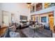 Spacious living room with high ceilings, grand balcony, comfortable leather seating, and unique decor at 118 Harbor View Ln, Belleair Bluffs, FL 33770