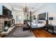Spacious main bedroom featuring a stone fireplace, a four-poster bed, and access to a sunny sitting area at 118 Harbor View Ln, Belleair Bluffs, FL 33770