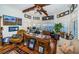 Home office with custom wood desk, hardwood floors, plantation shutters and lots of light at 118 Harbor View Ln, Belleair Bluffs, FL 33770