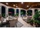 Outdoor dining area on covered patio with lovely views of the lush landscaping and pool at 118 Harbor View Ln, Belleair Bluffs, FL 33770
