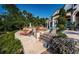 Backyard with swimming pool, lounge chairs and lush landscaping at 118 Harbor View Ln, Belleair Bluffs, FL 33770