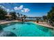 Swimming pool overlooking the water with lounge chairs and dining set at 118 Harbor View Ln, Belleair Bluffs, FL 33770
