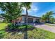 Two-car garage, landscaped yard, and paver driveway of this beautiful home at 12115 Amica Loop, Venice, FL 34293