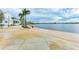 Relaxing lakeside walkway with seating and palm trees at 12115 Amica Loop, Venice, FL 34293