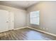 Well-lit bedroom with wood-look floors and closet at 1252 Highwood Pl, Wesley Chapel, FL 33543