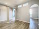 Hallway with wood-look floors and arched doorways at 1252 Highwood Pl, Wesley Chapel, FL 33543