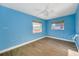 Blue bedroom with tiled floors and ceiling fan at 14017 Miramar Ave, Madeira Beach, FL 33708